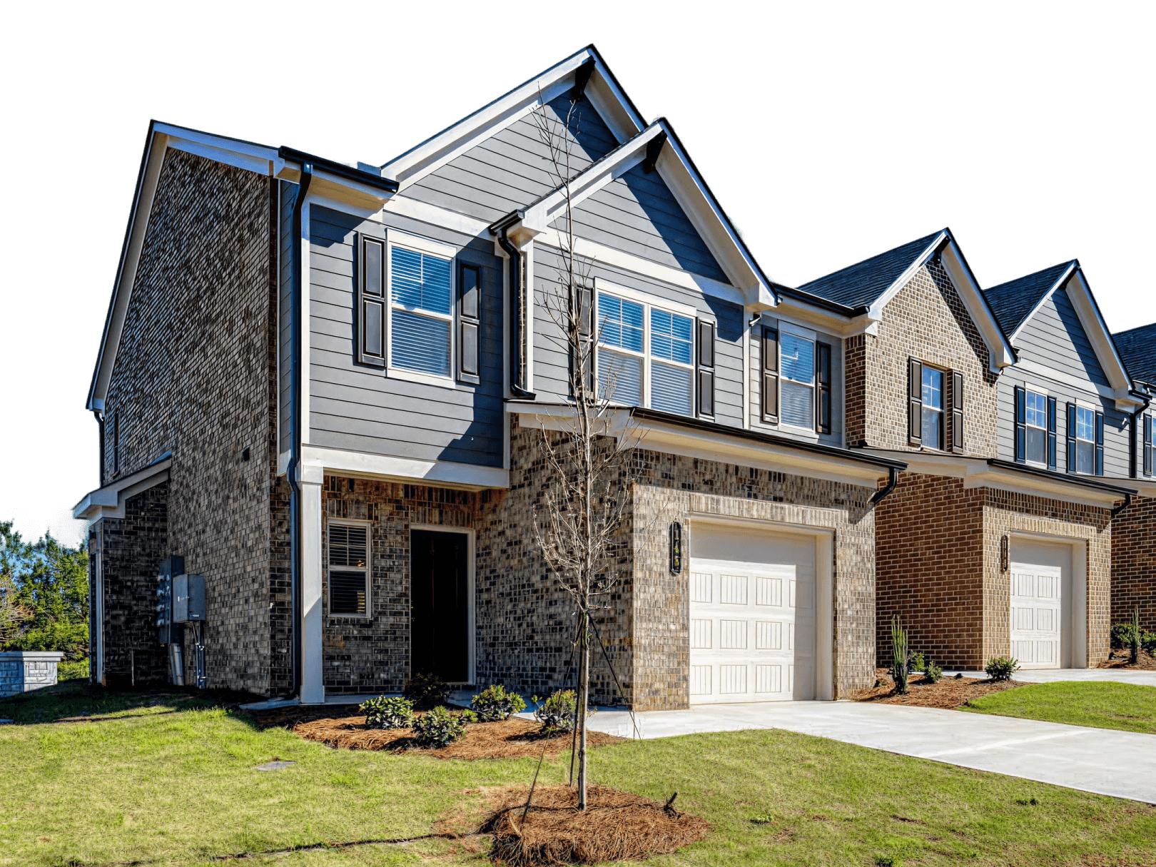 Modern Townhouse Community Front View Row of contemporary two-story townhouses with brick facades, white garage doors, and manicured lawns in residential neighborhood.