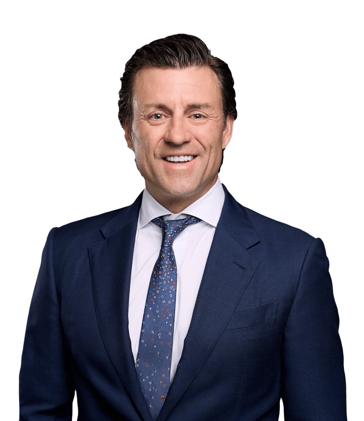 Nathan Pramik Professional Business Portrait Professional headshot of Nathan Pramik wearing a navy blue suit and patterned tie, smiling at camera