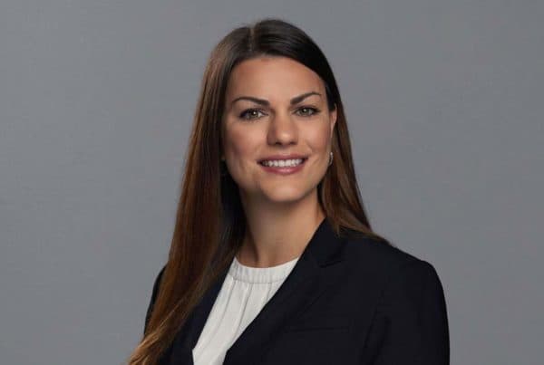 Candler Callan Professional Portrait Professional headshot of Candler Callan, a woman with long brown hair wearing a black blazer and white blouse, smiling at camera