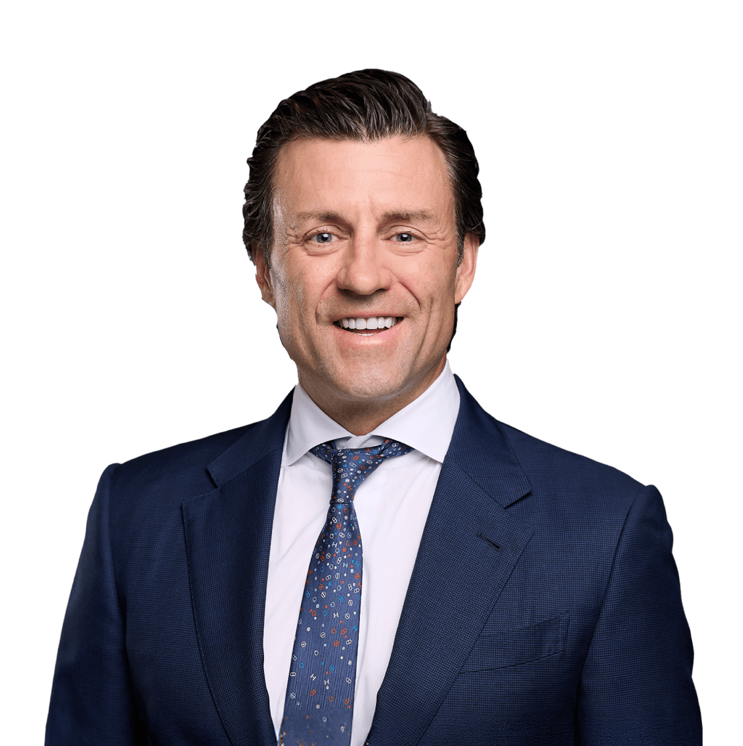 Nathan Pramik Professional Headshot Portrait Professional headshot of Nathan Pramik smiling, wearing a navy blue suit and patterned tie against white background